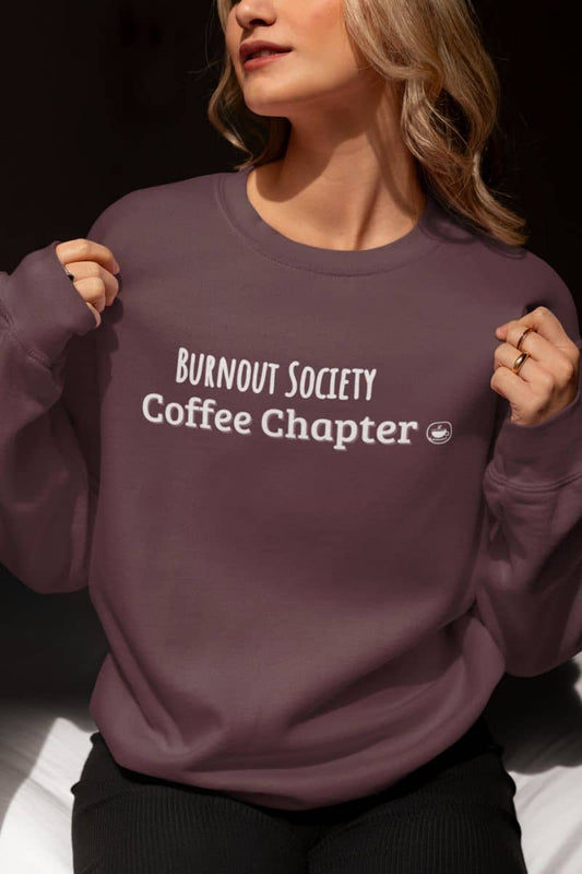 Burnout society coffee sweatshirt with a person wearing a purple sweatshirt with 'Burnout Society Coffee Chapter' text.