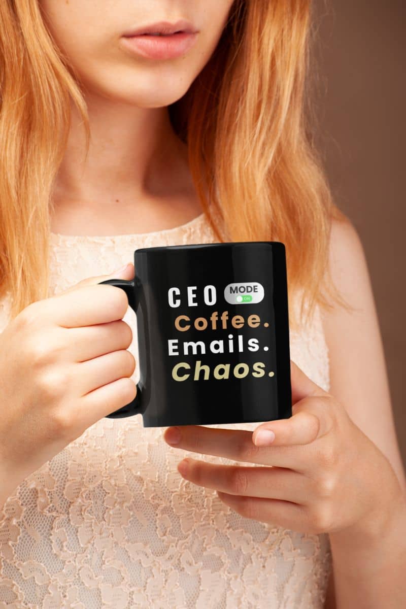 CEO lifestyle mug featuring a girl holding a black mug with text 'CEO Mode: Coffee. Emails. Chaos.'