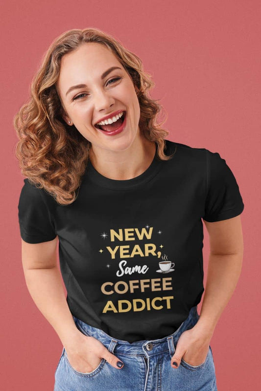 Caffeine addict shirt with a woman wearing a black t-shirt with 'New Year, Same Coffee Addict' text on a pink background