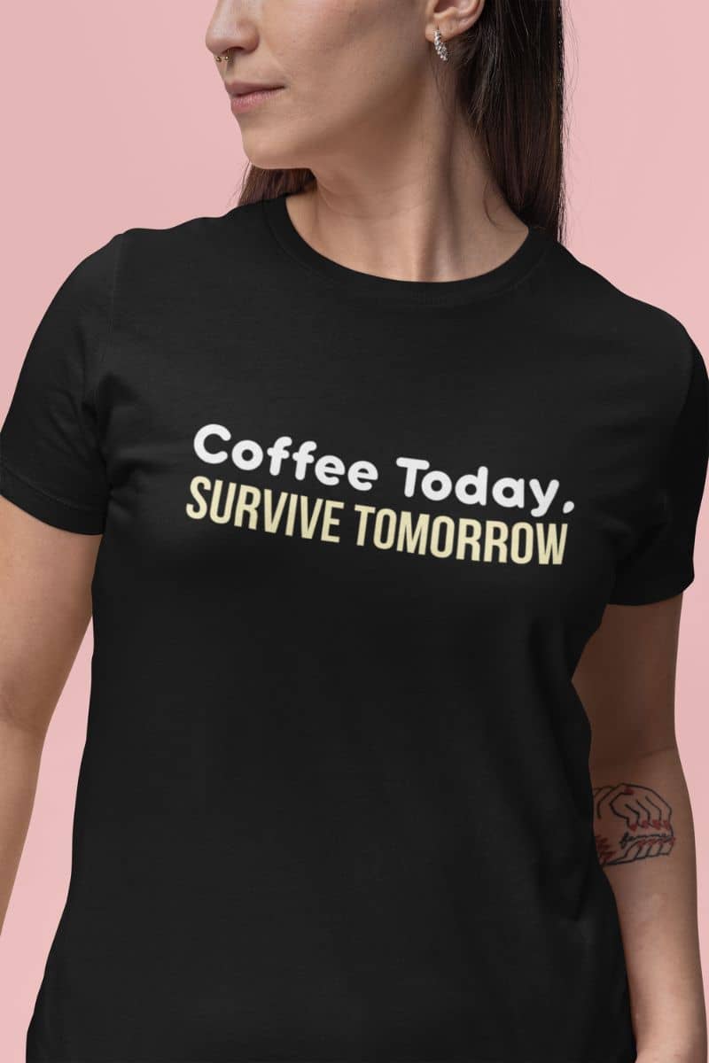 Caffeine lover graphic tee with a person in a black t-shirt with 'Coffee Today, Survive Tomorrow' text on a pink background
