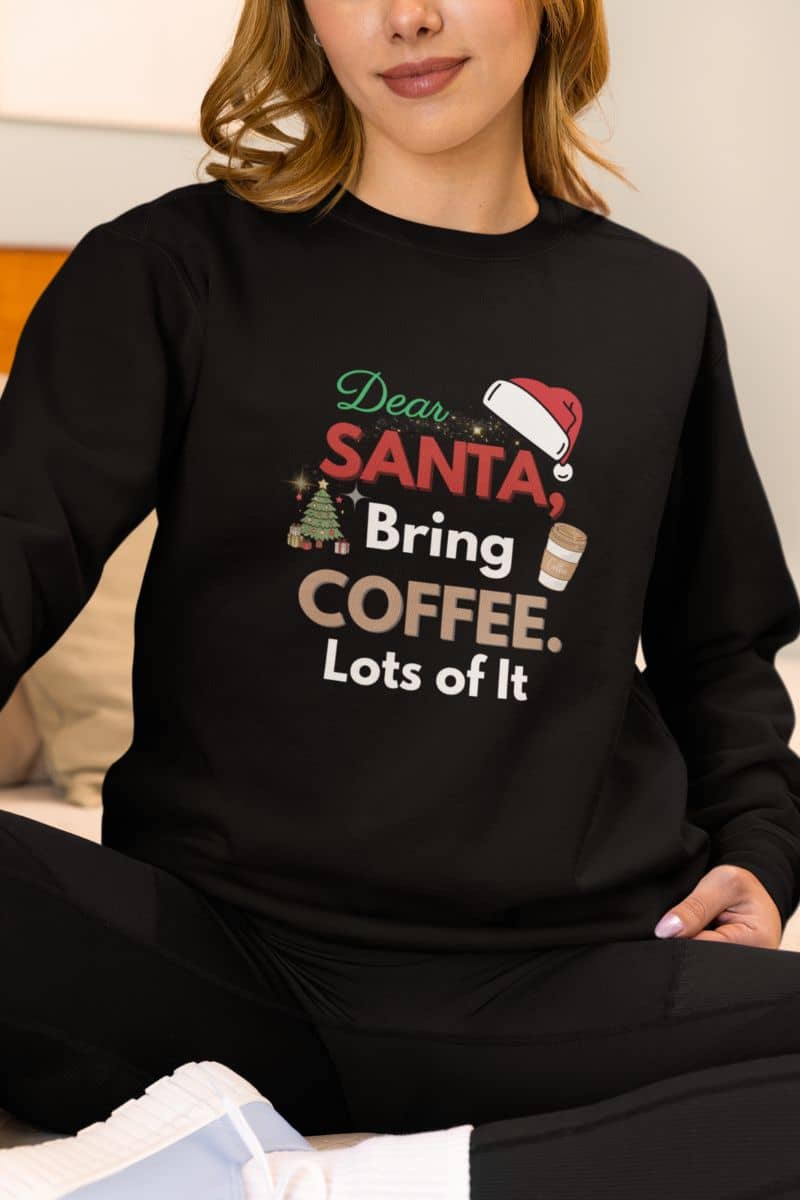 Christmas coffee sweatshirt with a person wearing a black sweatshirt with text 'Dear Santa, Bring Coffee. Lots of It.'