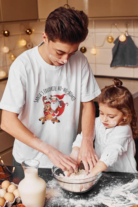 Christmas unisex T-shirt with a young man teaching a little girl how to make cakes