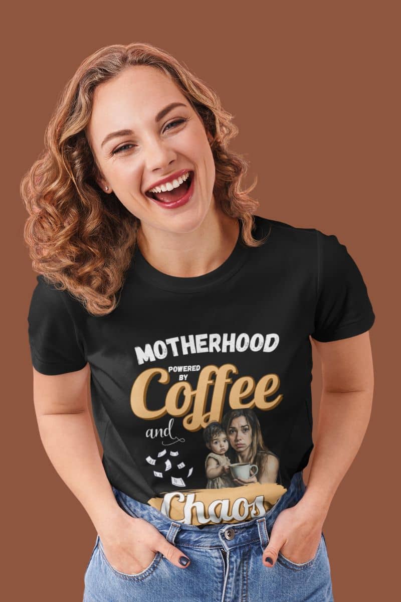 Coffee lover mom shirt with a woman wearing a black t-shirt with text 'Motherhood: Powered by Coffee and Chaos.' 
