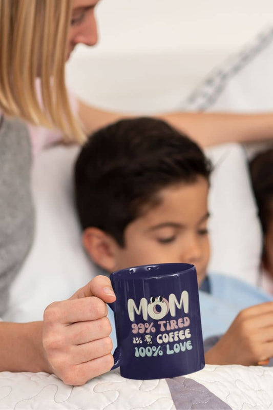 Coffee mug for moms with a mother lying in bed with her children while still holding a cup of coffee