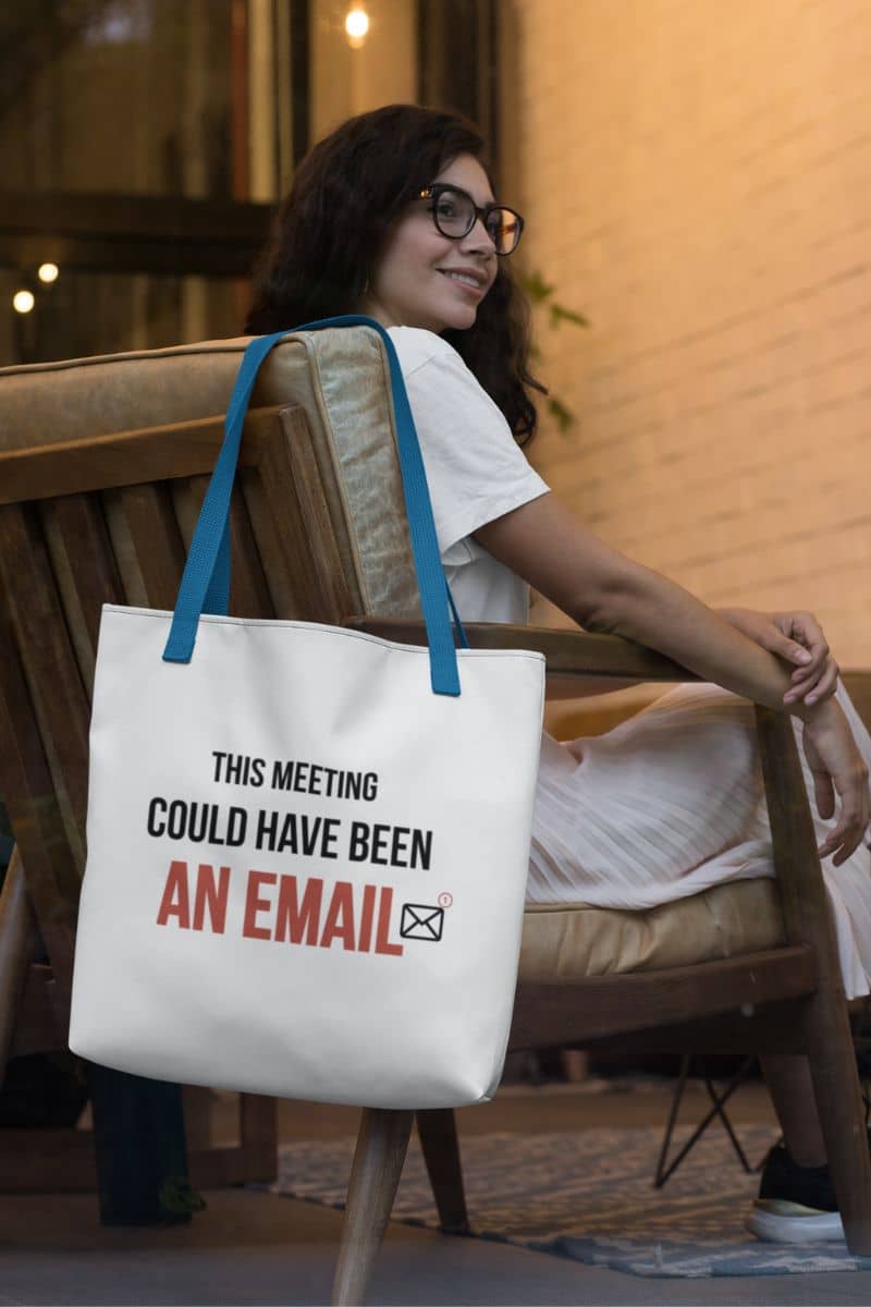 Corporate tote bag with a woman sitting on a chair with a tote bag that says 'This meeting could have been an email'.