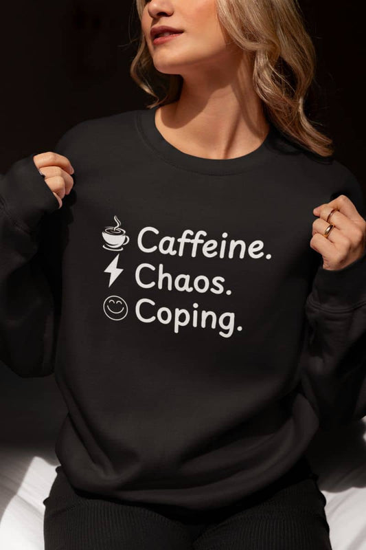 Cozy chaos sweatshirt with a person wearing a black sweatshirt with 'Caffeine. Chaos. Coping.' text
