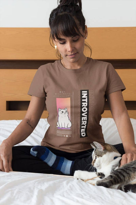 Cozy introverted t-shirt with a girl sitting playing with her cat on her bed