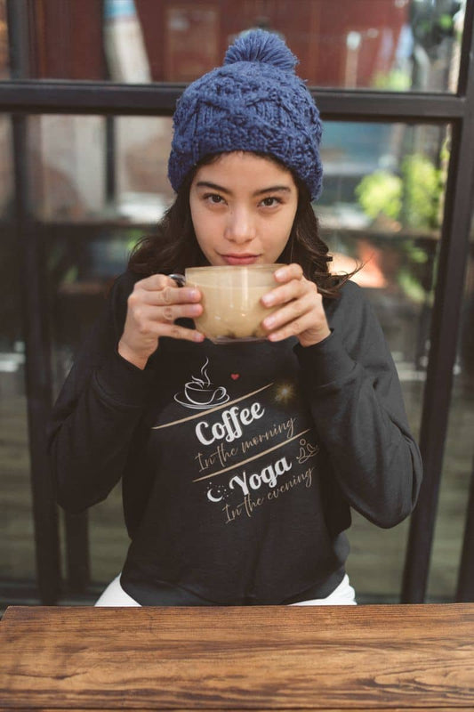 Cozy pullover sweatshirt with a young girl drinking a cup of coffee in a coffee shop