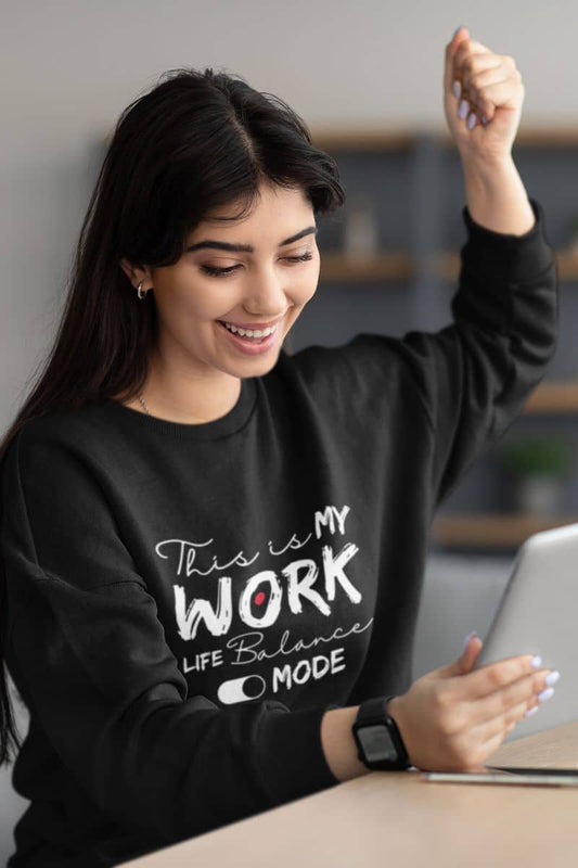 Cozy work-life balance sweatshirt with a girl excited and smiling while watching on tablet