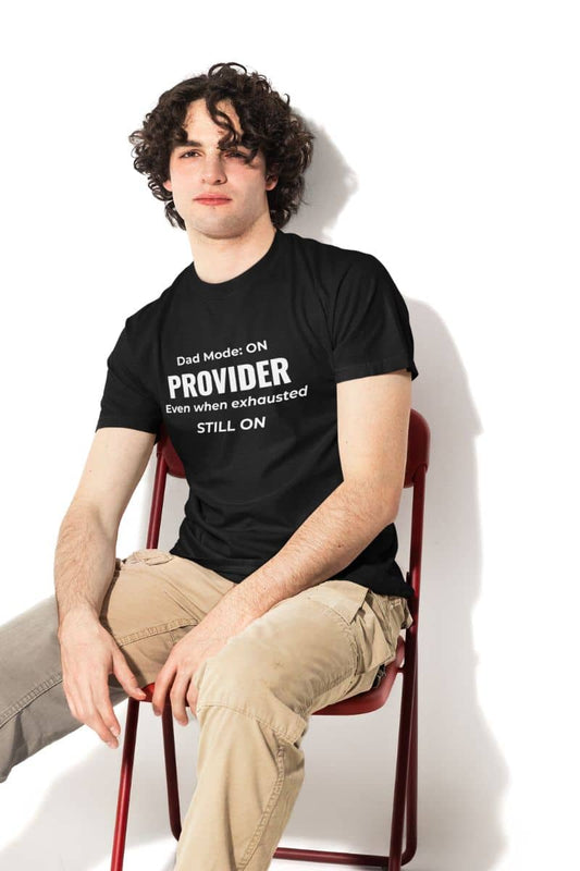 Dad shirts from daughter with a young man wearing a t-shirt featuring the text 'Dad Mode: On. Provider. Even when exhausted. Still on'
