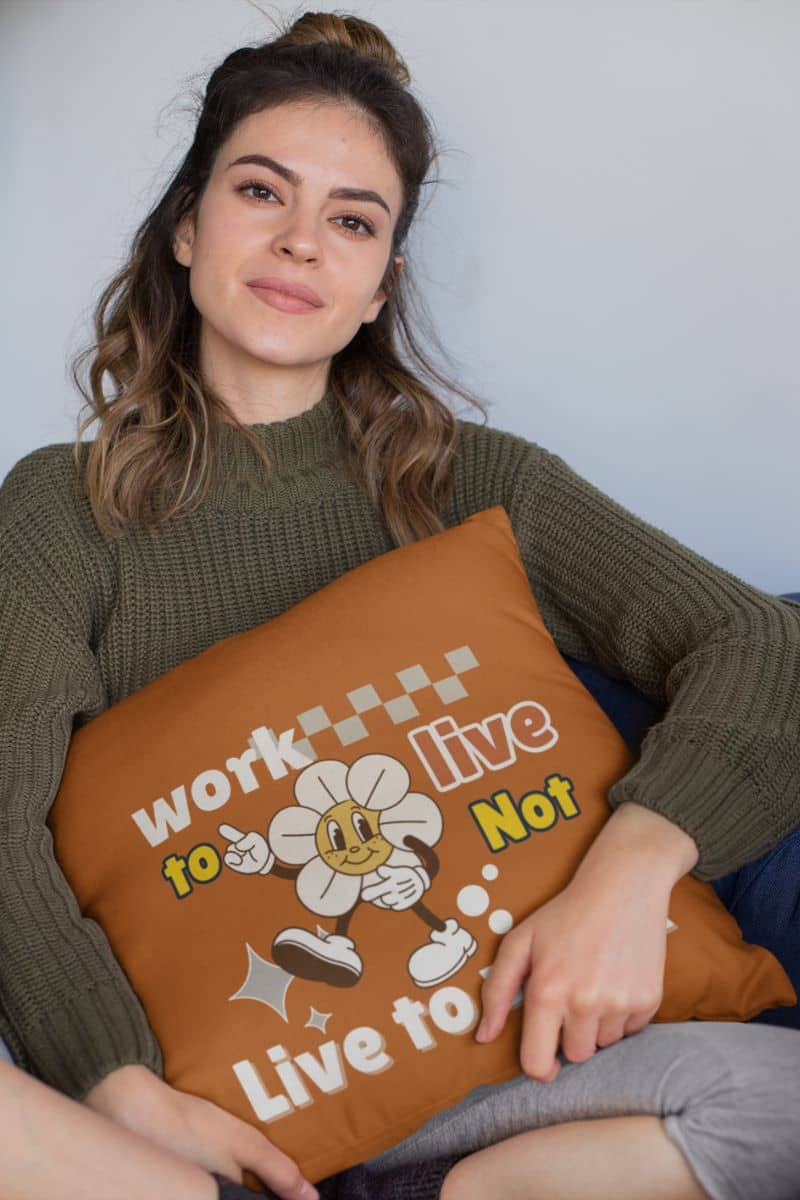 Decorative quote pillow with a woman sitting on the sofa hugging a large pillow with a thoughtful expression