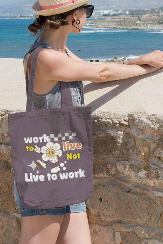 Eco-friendly tote bag with a girl standing on the wall looking down at the sea