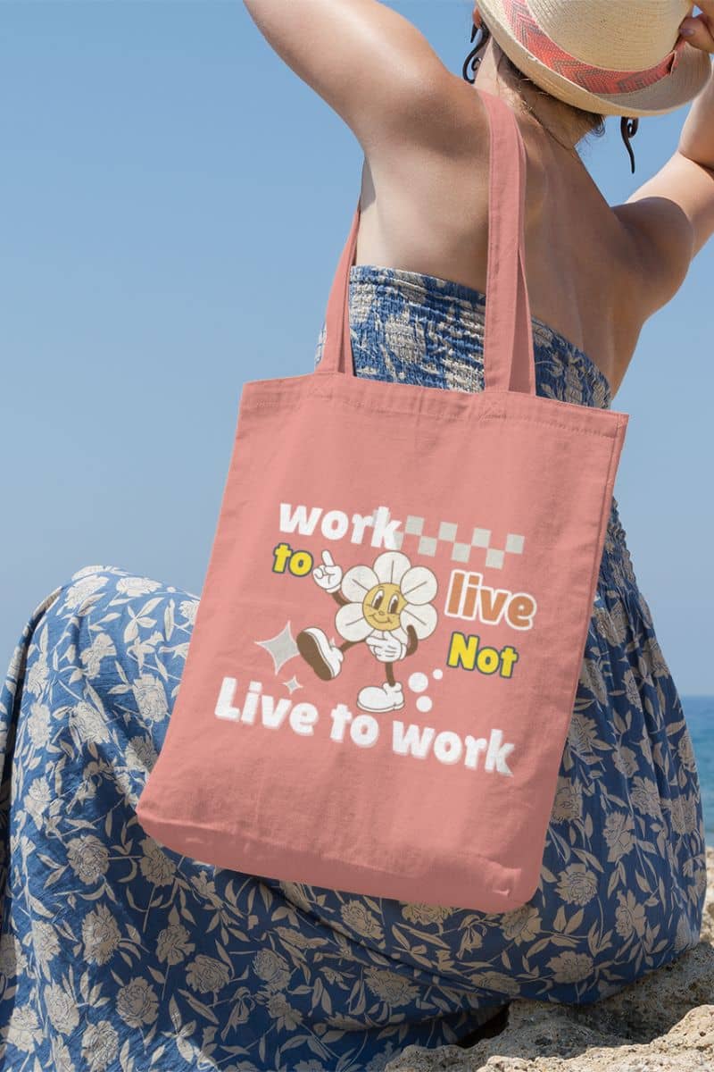 Eco-friendly tote bag with a girl wearing a beach dress sitting on the shore looking down at the sea