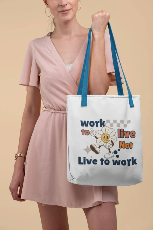 Eco-friendly tote bag with a woman holding a tote bag with a motivational quote 'Work to Live, Not Live to Work' and cartoon character on a beige background