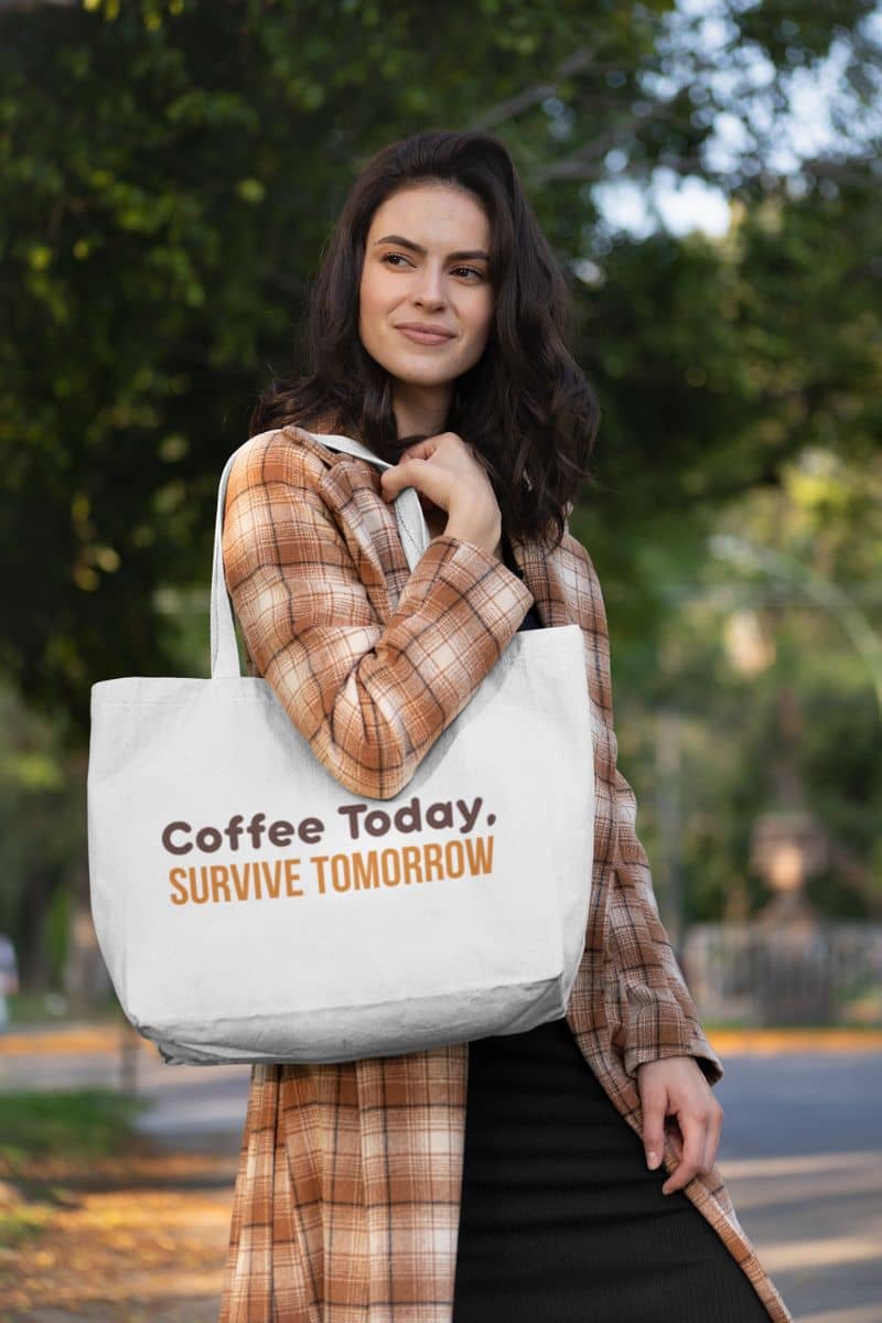 Espresso lover bag with a woman holding a tote bag with 'Coffee Today, Survive Tomorrow' text outdoors.