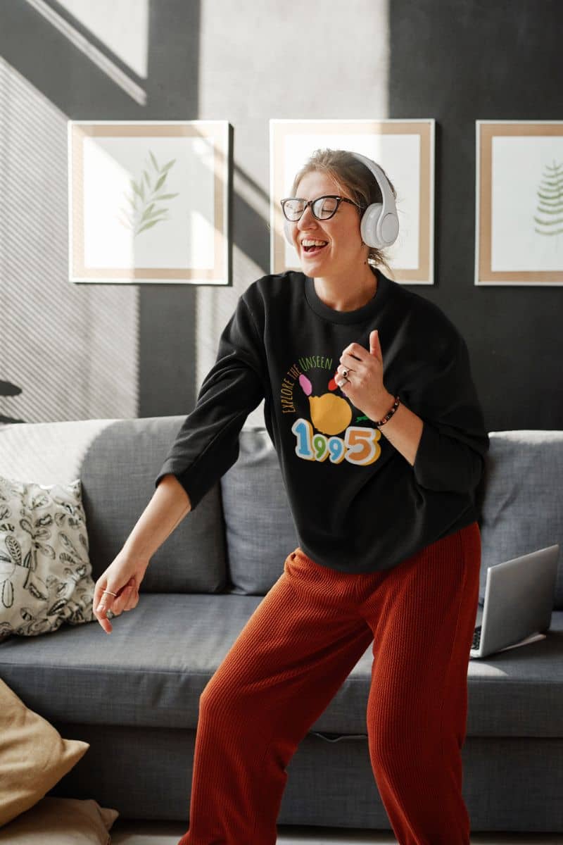 Explore the Unseen Sweatshirt with the girl wearing headphones and grooving to the music