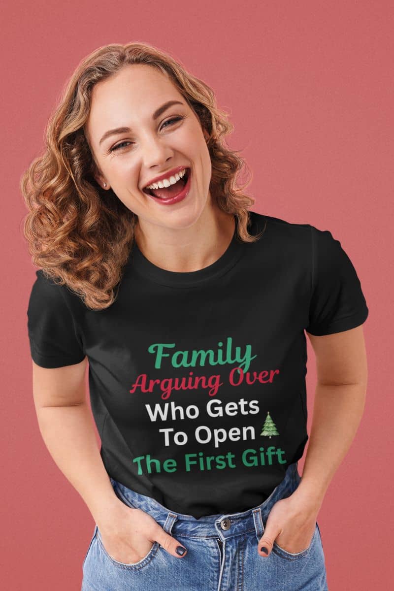 Family holiday humor shirt with a woman wearing a black t-shirt with humorous text on a pink background