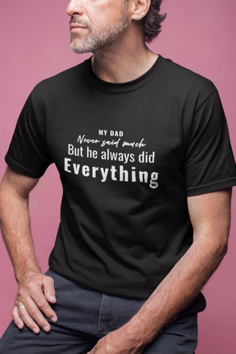 Fathers day t shirt with a man wearing a black t-shirt with text 'My Dad Never Said Much, He Always Did Everything' on a pink background