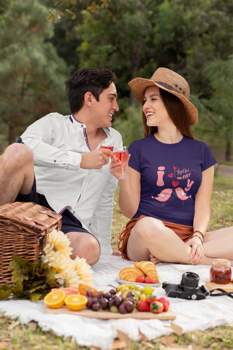 Forever love birds t-shirt with a couple clinking glasses together while having a picnic outdoors