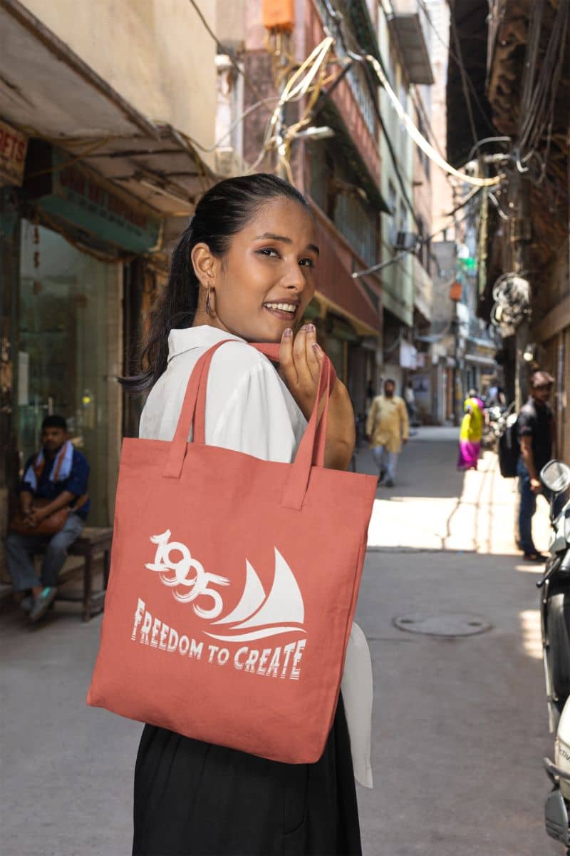 Freedom to Create Tote Bag with the girl carrying the tote bag and looking back
