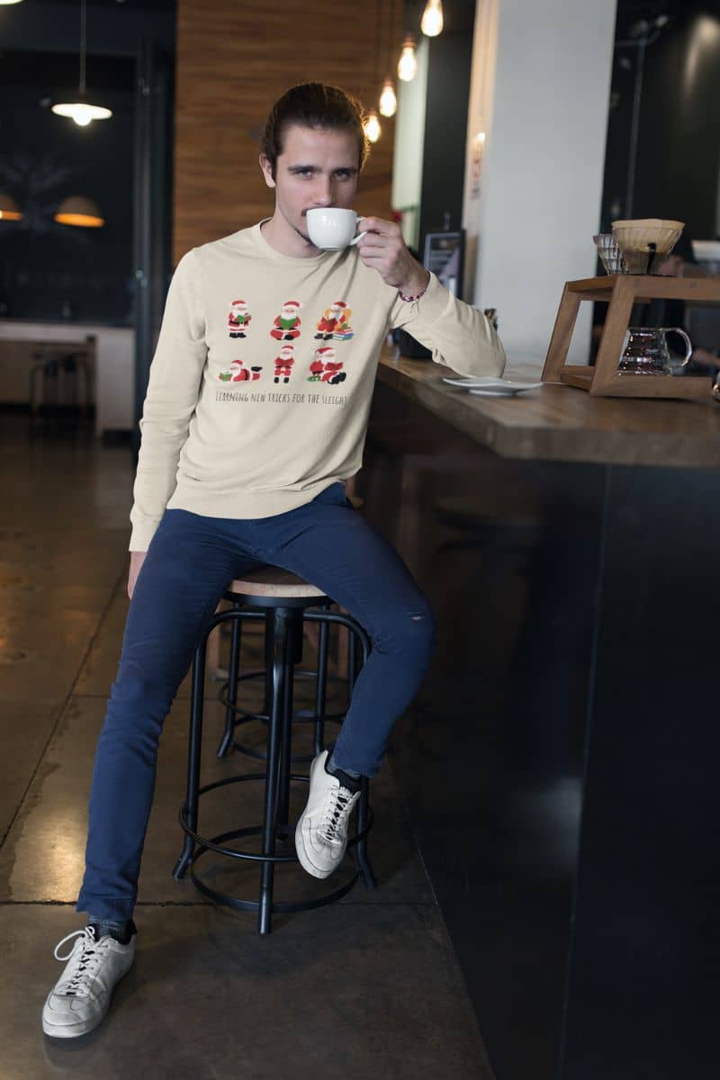 Learning New Stricks For The Sleigh - Fun Christmas Sweatshirt with a guy drinking tea in the kitchen