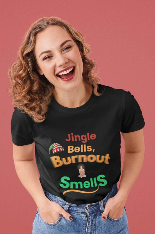 Funny christmas burnout shirt with a woman wearing a black t-shirt with humorous text 'Jingle Bells, Burnout Smells' on a pink background