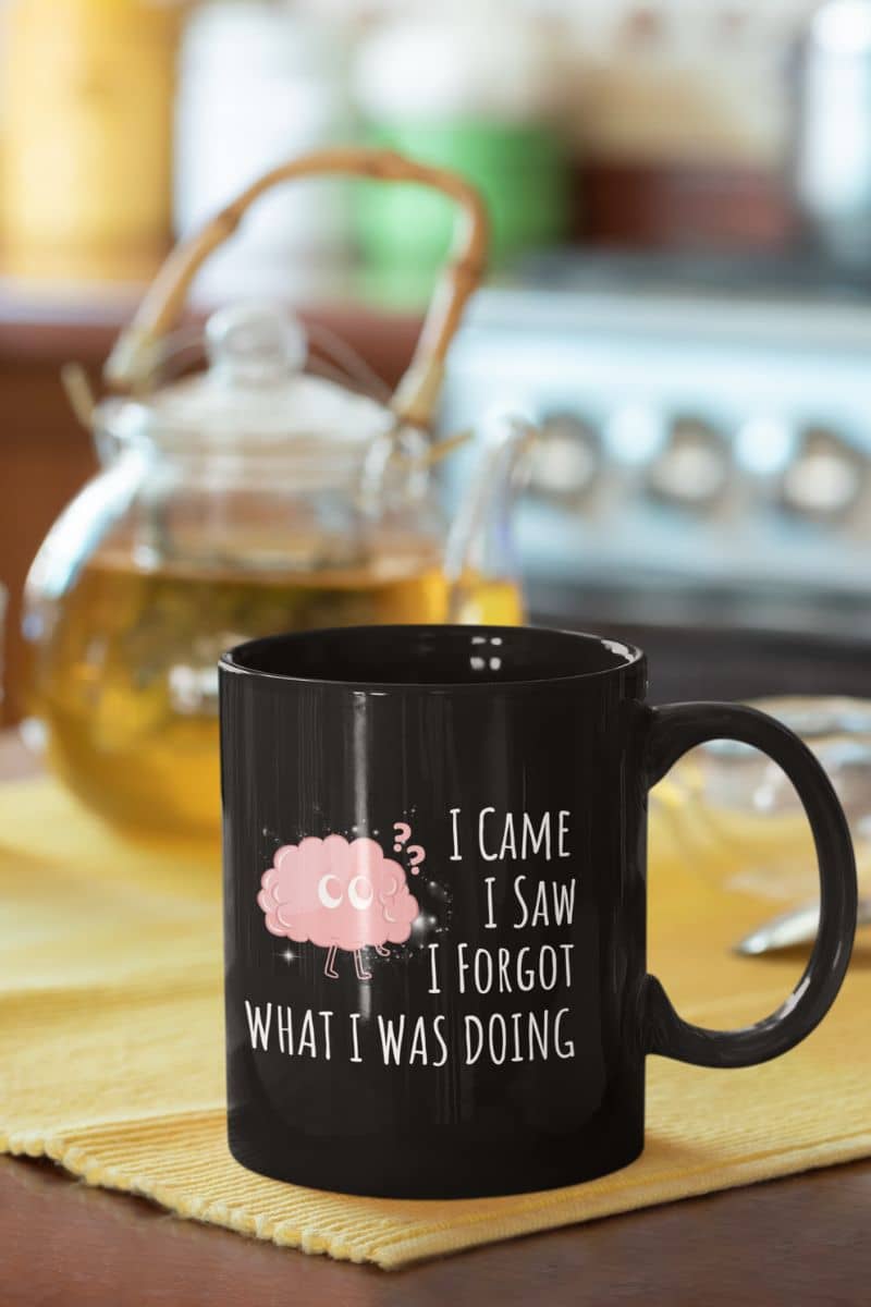 Funny coffee mug with a coffee cup in front of the teapot