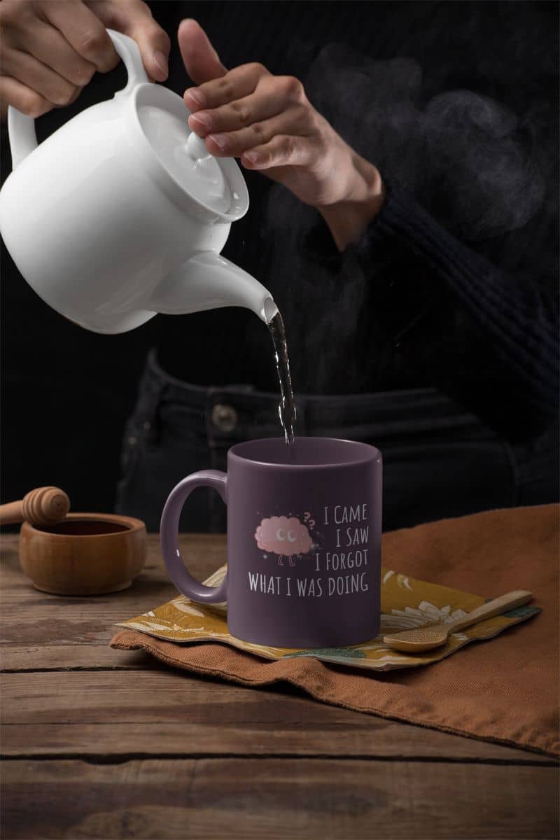 Funny coffee mug with a woman pouring water from a teapot into a coffee cup