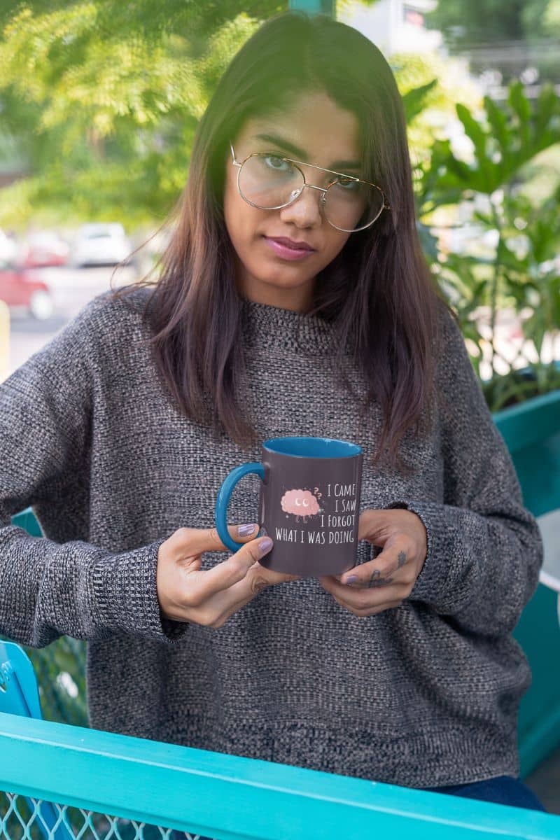 Funny coffee mug with a girl holding a cup posing on the balcony