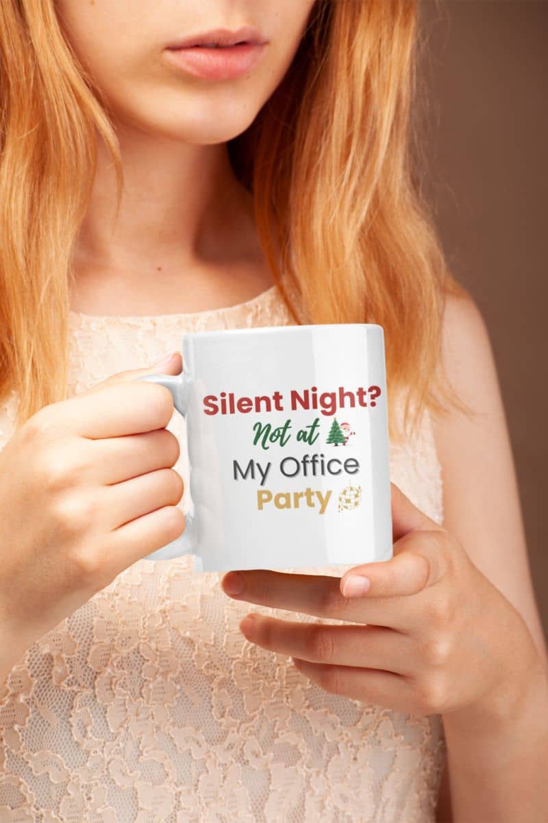 Funny coworker Christmas mug with a person holding a mug with text 'Silent Night? Not at My Office Party' against a neutral background