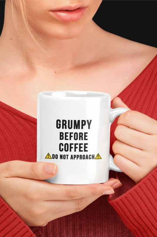 Funny coworker mug with a woman holding a mug with text 'Grumpy before coffee, do not approach'