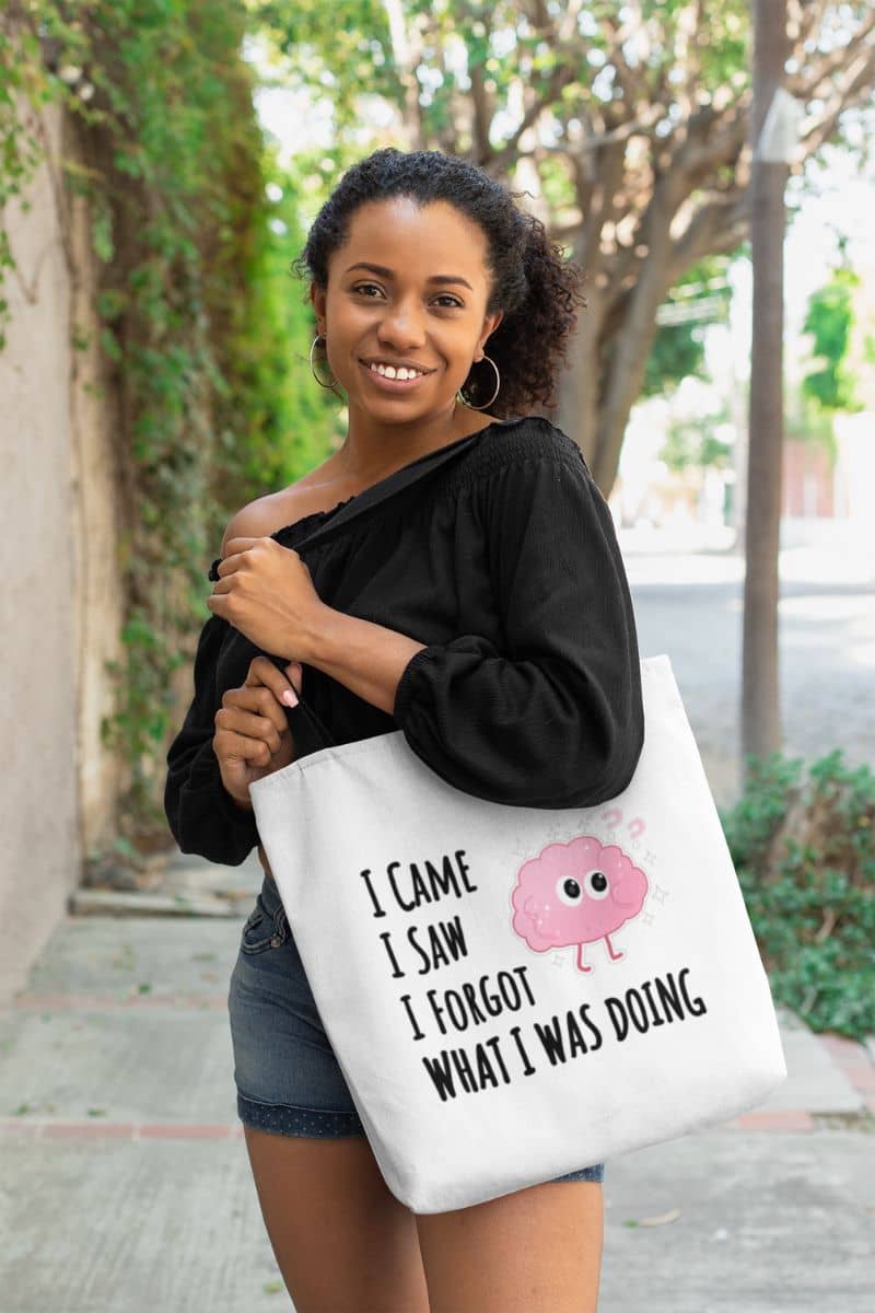 Funny forgetful tote bag with a woman holding a tote bag featuring the text 'I came, I saw, I forgot what I was doing'