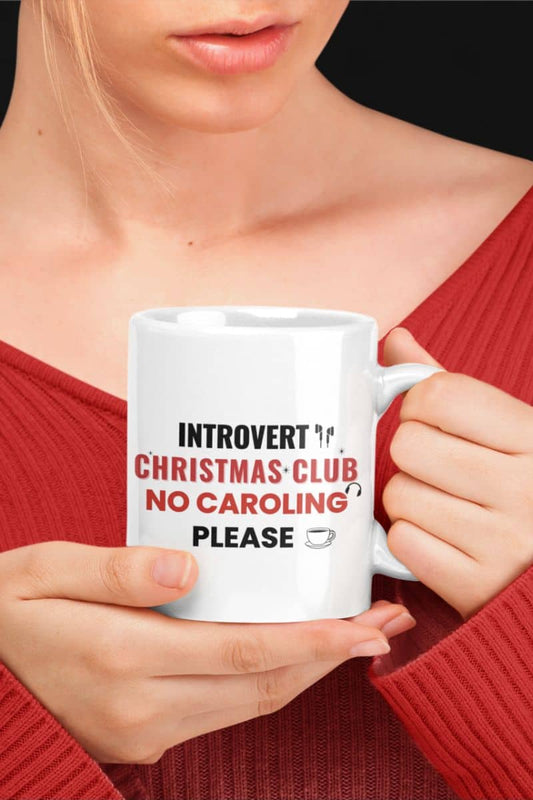 Funny introvert mug with a person holding a mug featuring text 'Introvert Christmas Club, No Caroling Please'