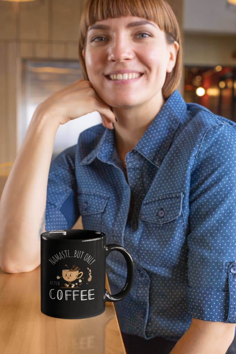 Funny mindful coffee mug with a girl sitting with her arms on the table and a cup of coffee next to her