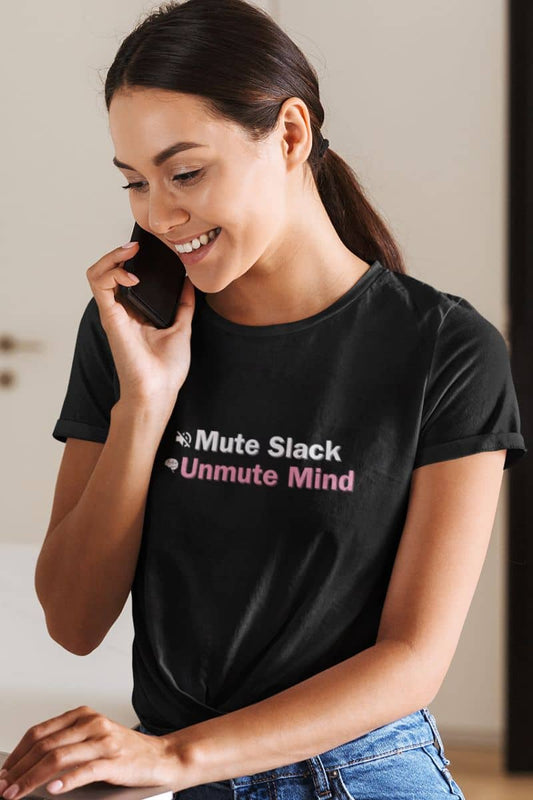 Funny work t-shirt for mental health with a woman wearing a black t-shirt with text "Mute  Slack Unmute Mind", smiling and talking on a phone.