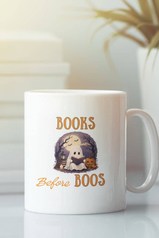 Halloween mug with a white mug featuring the text 'Books Before Boos', placed on the table