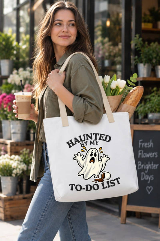 Halloween totes design featuring a “Haunted by My To-Do List” funny ghost, shown on a woman walking outdoors