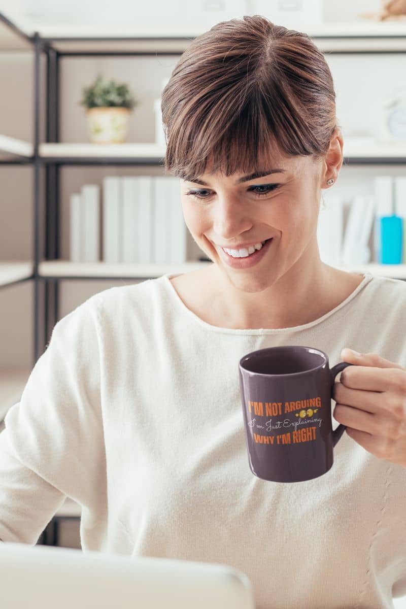 Hilarious coffee mug for work with a girl smiling while working on a laptop while still holding a cup to prepare to drink