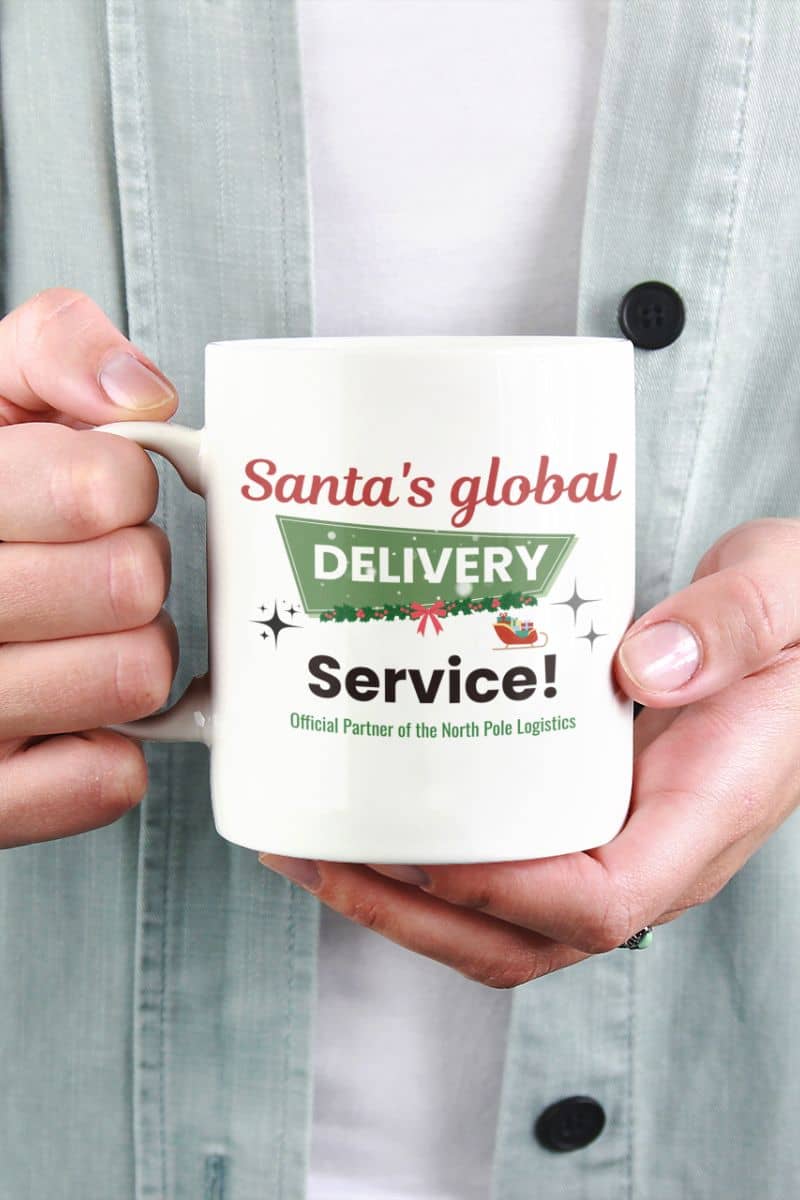 Holiday coffee mug gift with a person holding a mug with 'Santa's global delivery service' text