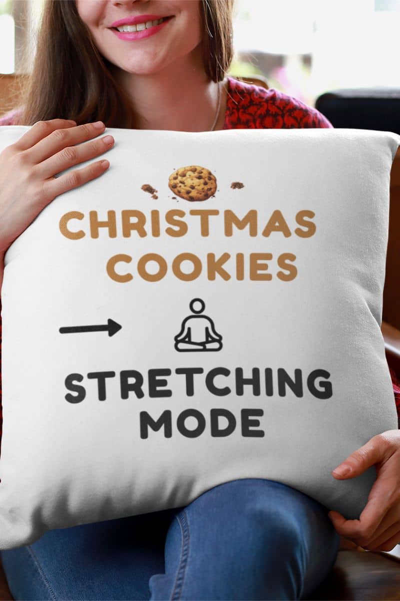 Holiday humor throw pillow with a person holding a pillow with 'Christmas Cookies,  Stretching Mode' text