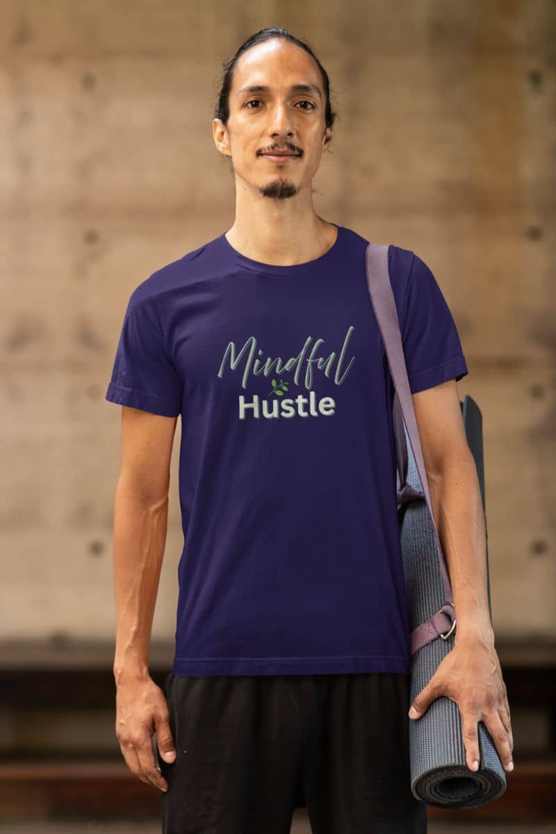 Hustle mindset t-shirt with a man wearing a purple 'Mindful & Hustle' t-shirt holding a yoga mat.