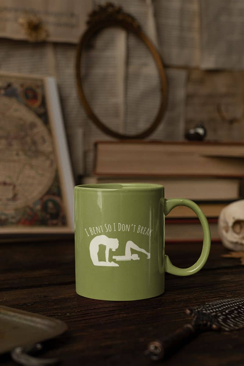 I bent so I don't break mug with a cup on a wooden table