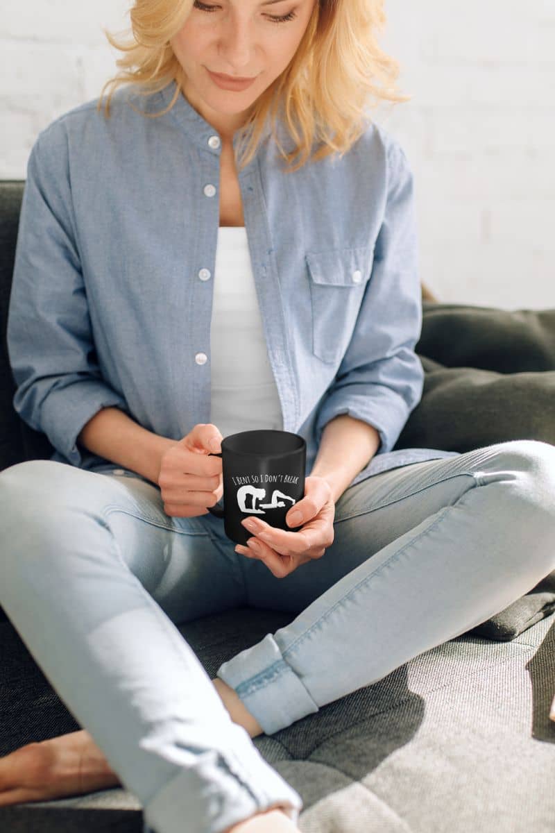 I bent so I don't break mug with a girl sitting on the sofa and looking at the cup