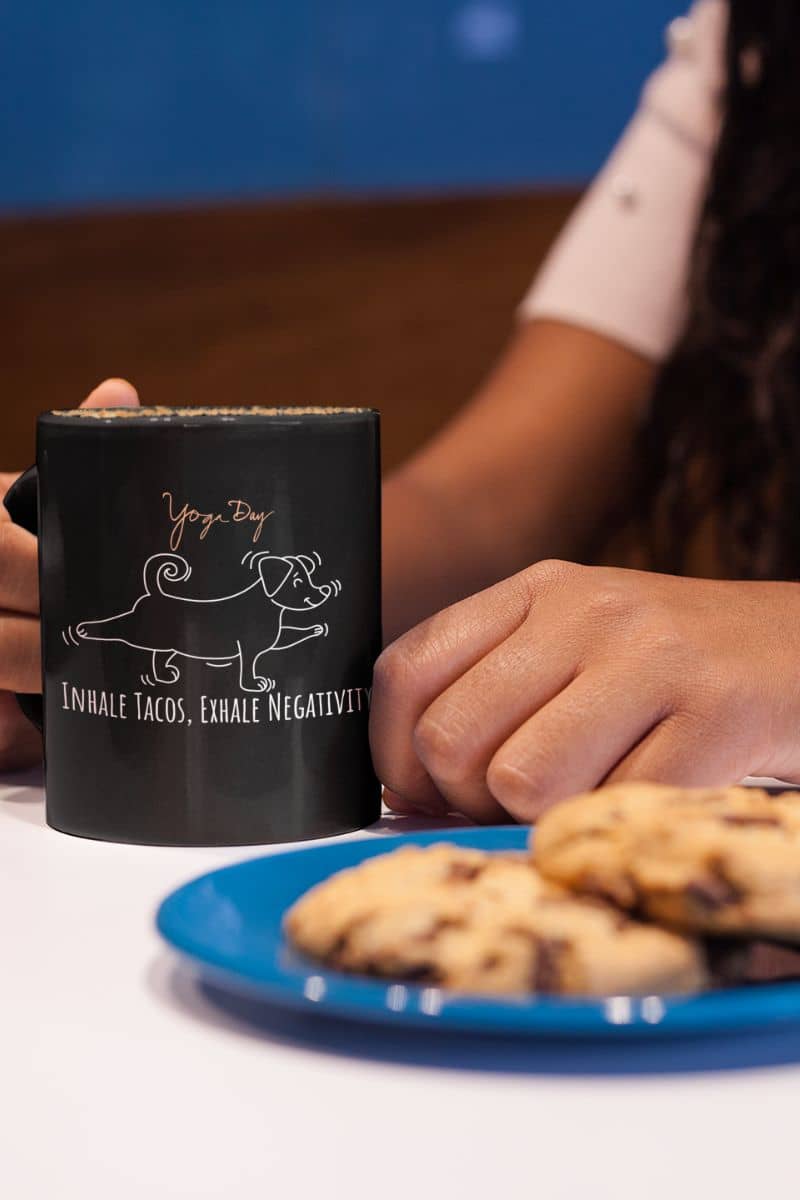 Inhale tacos, exhale negativity yoga mug with a girl holding a cup next to a plate of cookies