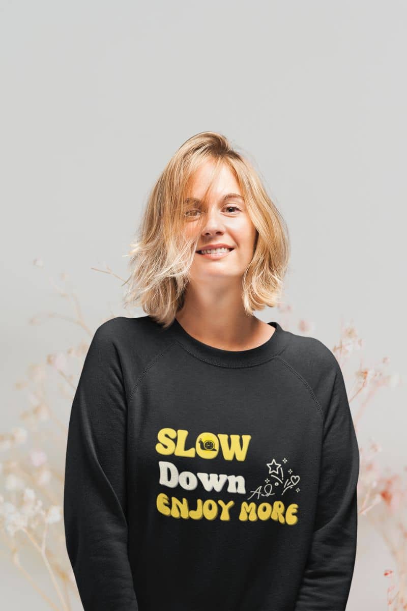 Inspirational pullover sweatshirt with a short-haired girl standing posing in front of a flower garden