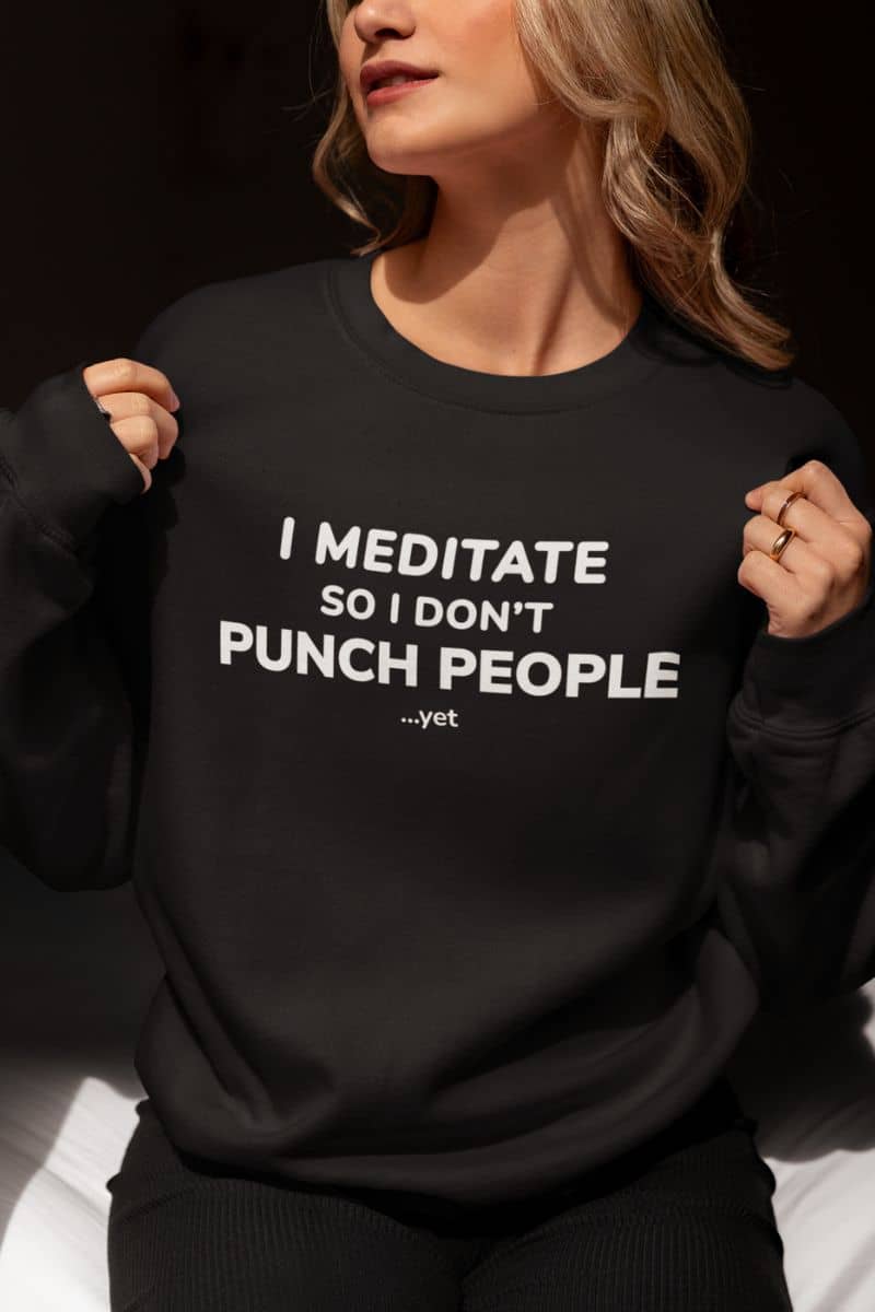 Introvert sweatshirt with a person wearing a black sweatshirt with text 'I Meditate So I Don’t Punch People...yet'