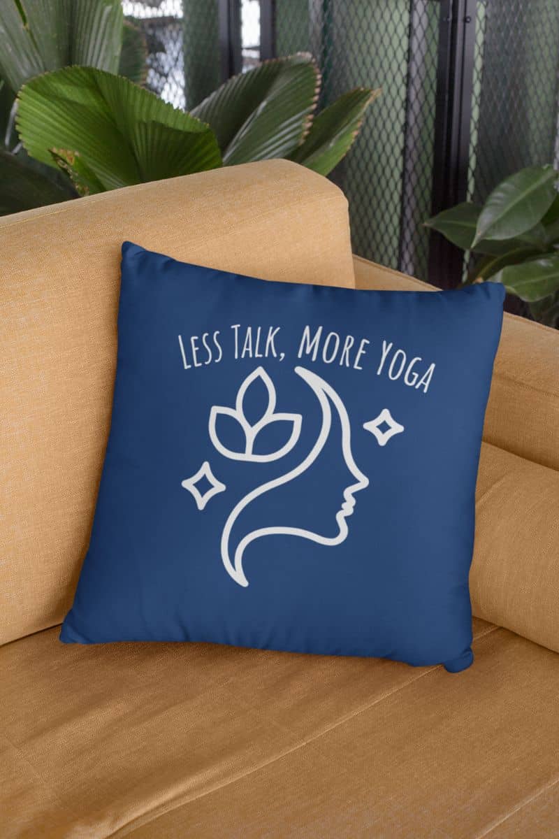 Experience Serenity with the Less Talk More Yoga Pillow with dark blue pillow on the sofa