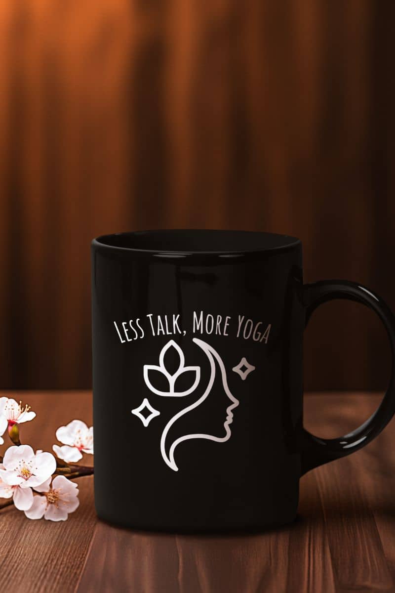 Less talk, more yoga mug with a black cup on the talble