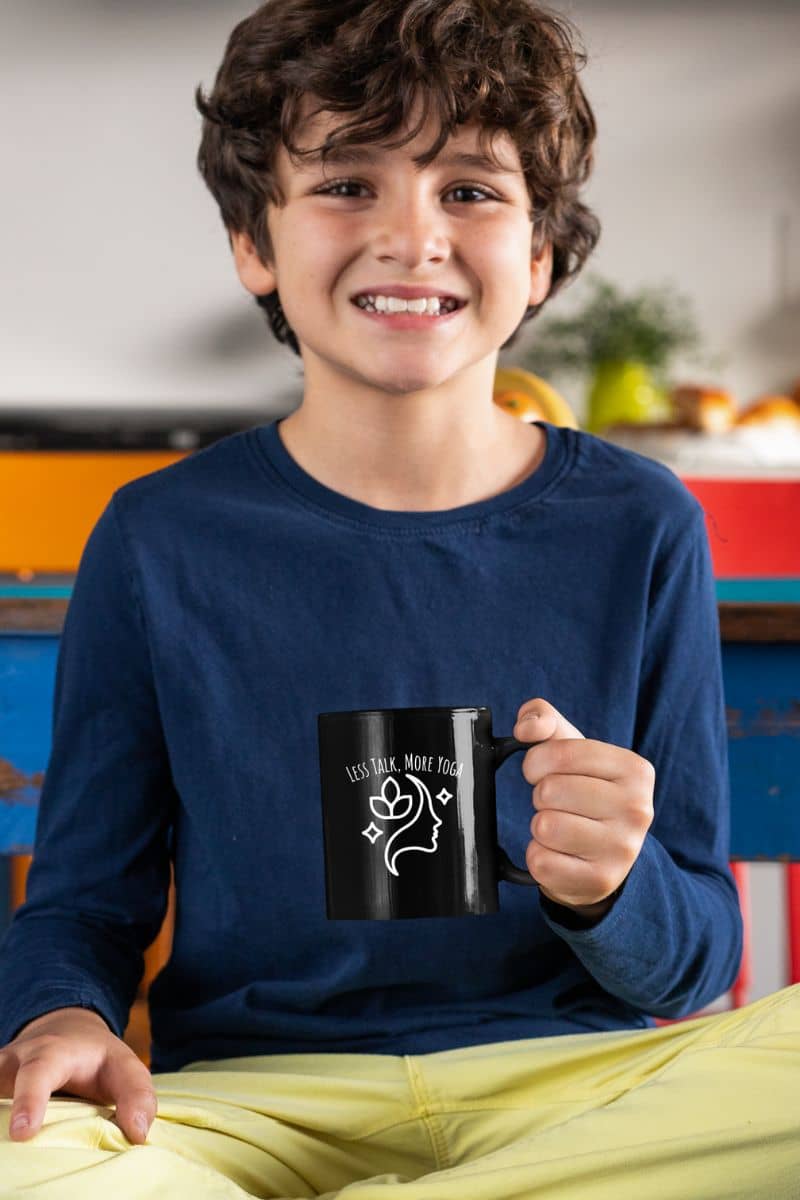 Less talk, more yoga mug with a boy holding a cup and smiling while sitting on the bed