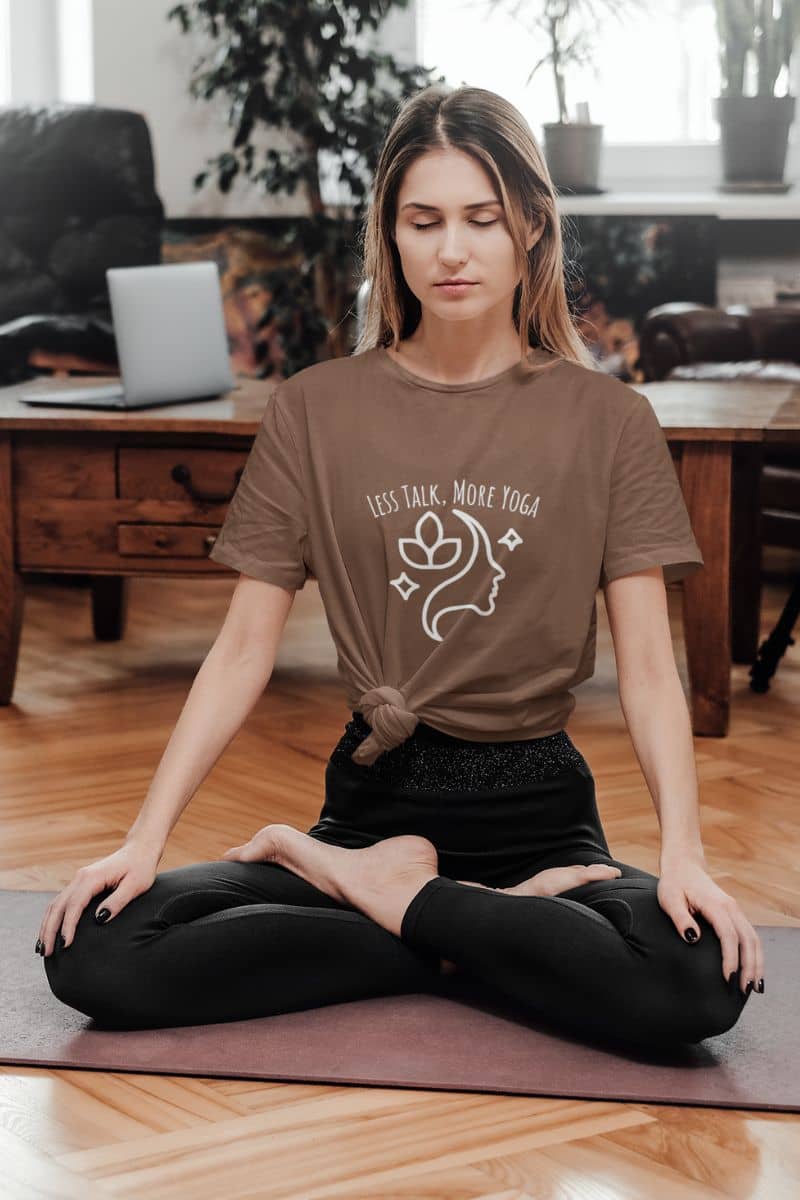 Less talk, more yoga t-shirt with girl practicing yoga at home in meditation pose on yoga mat